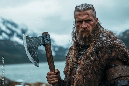Viking warrior stands poised with axe in rugged landscape surrounded by mountains and water