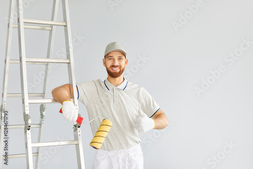 Portrait of a man painter or worker gives a thumbs up gesture during home renovation work. Confidence and professionalism, showcasing a skilled handyman engaged in a construction project. photo