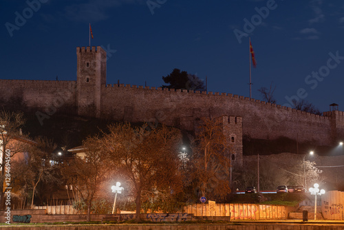 A nighttime view of Macedonia Square, the central plaza of Skopje. Illuminated buildings, monuments, and fountains create a vibrant atmosphere in the heart of the city. photo