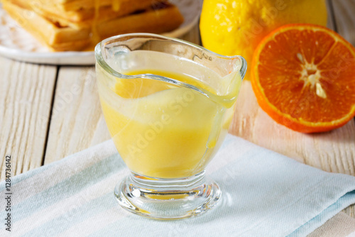 Obraz na płótnie Lemon-tangerine curd in a glass gravy boat, tangerine and lemon and Belgian waffles. w salonie
