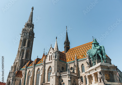 minimalist view of top of tower cathedral in hungarian architecture style over sunrise light