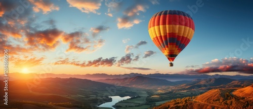 Hot air balloon in the blue sky over the mountains.