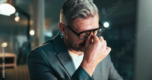 Office, eye strain and business man with headache, burnout and overworked on deadline at night on computer. Migraine, tired and mature manager with stress, vision fatigue and wrong frame on glasses