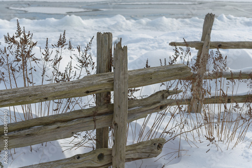 wooden fence on the beach in winter
