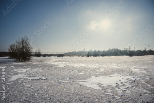 Sand quarry in th Vilnohirsk , Ukraine. Winter landscape on the sand quarry ,sun rays on the sy , beautiful colors on the picture . Path on the sand . Road and trees with lights of the sun . Trees 