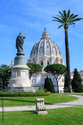 A statue of St Peter in the Vatican Gardens. The dome of St Peter’s Basilica seen in the background.