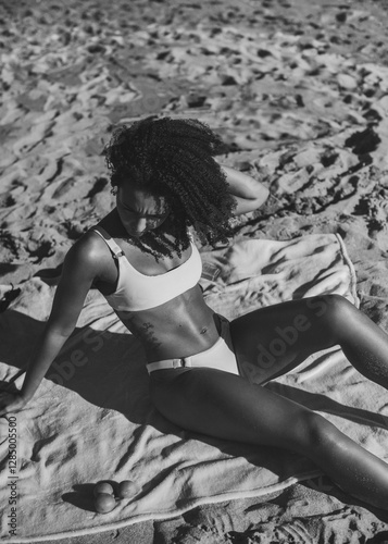 Athletic young woman in a bikini sunbathing and relaxing at the beach