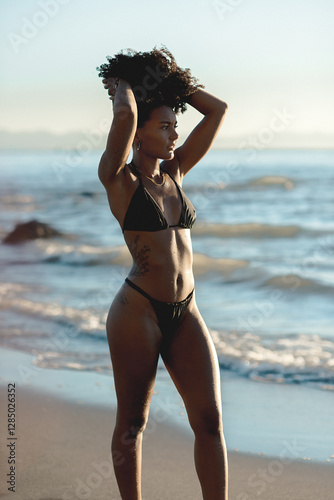 Athletic young woman in a bikini sunbathing at the beach
