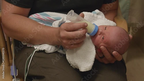Closeup of a Father Bottle Feeding His Newborn baby at the NICU
