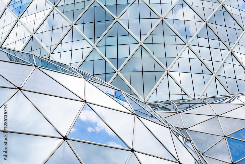 Blue sky and clouds reflecting in windows of modern office building Blue sky and clouds reflecting in windows of modern office building