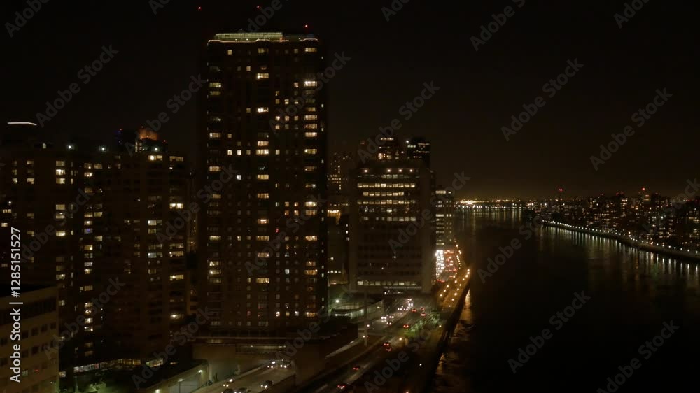 A stunning city skyline at night features illuminated buildings and a scenic river view A stunning city skyline at night features illuminated buildings and a scenic river view