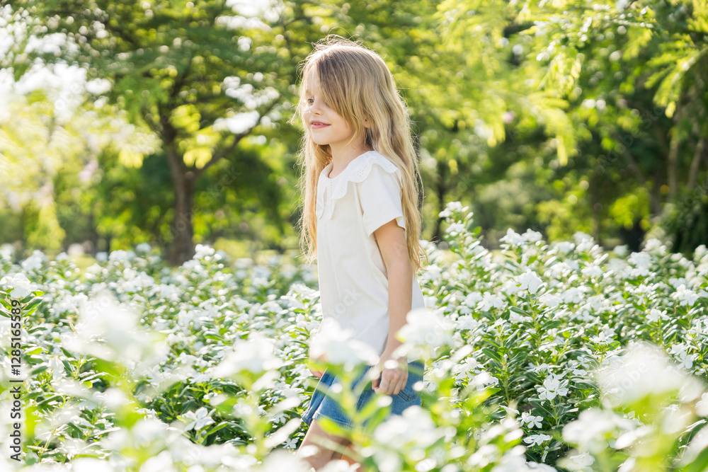 Little girl playing in the garden with morning sunrise Little girl playing in the garden with morning sunrise
