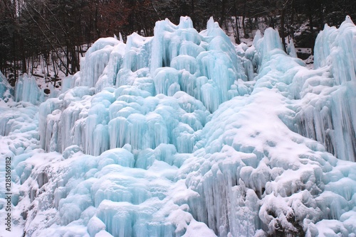 Bluish ice formations on frozen waterfall