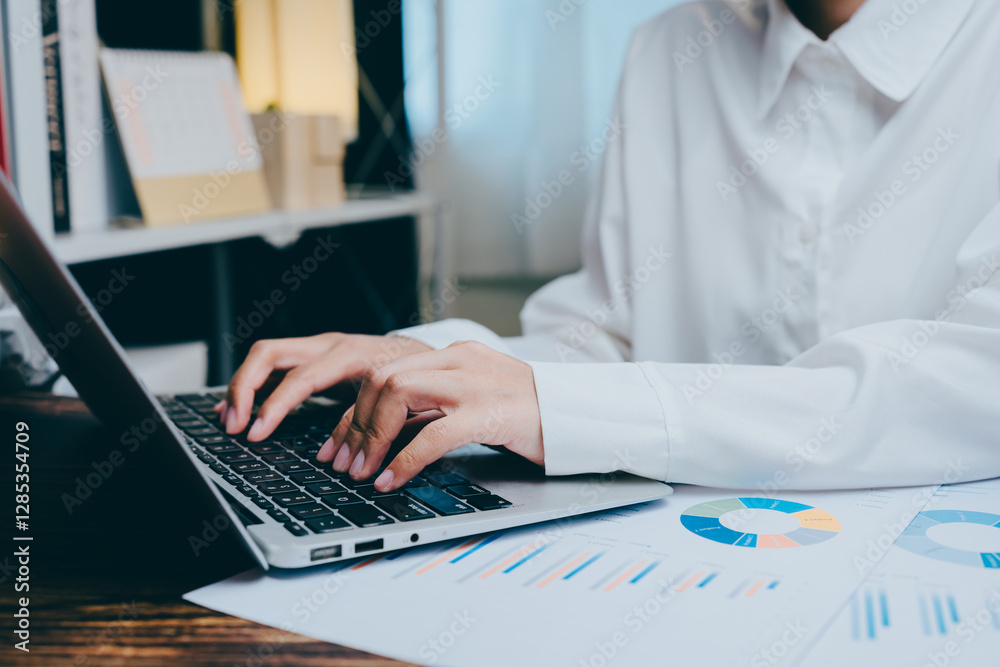 © JK_kyoto - Business professional working on laptop with graphs and charts ?, business concept © JK_kyoto - Business professional working on laptop with graphs and charts ?, business concept