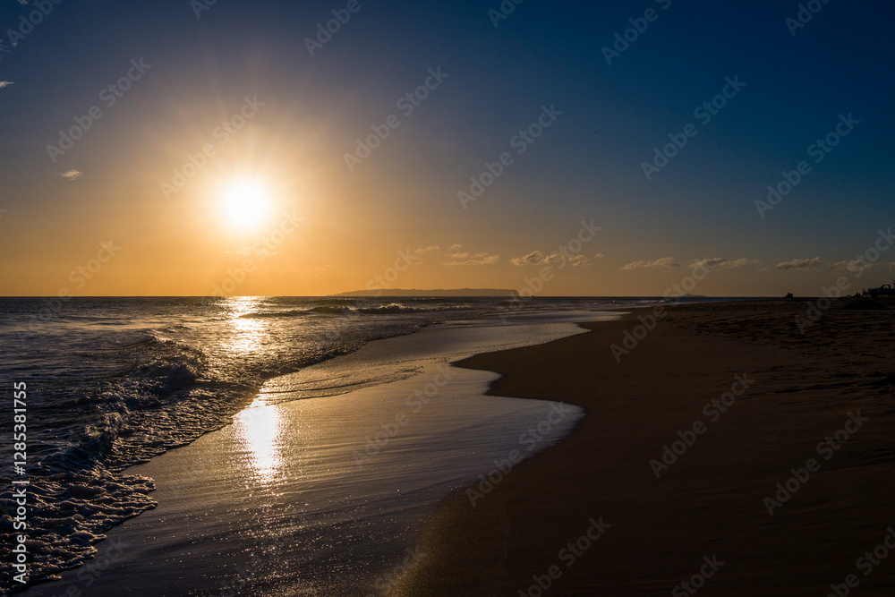 Sunset Over a Serene Beach with Gentle Waves Sunset Over a Serene Beach with Gentle Waves