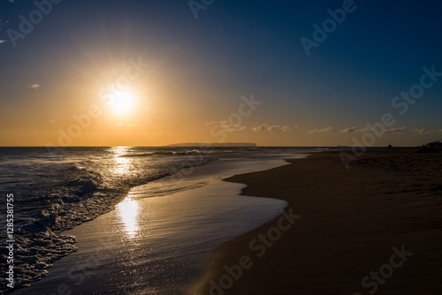 Sunset Over a Serene Beach with Gentle Waves