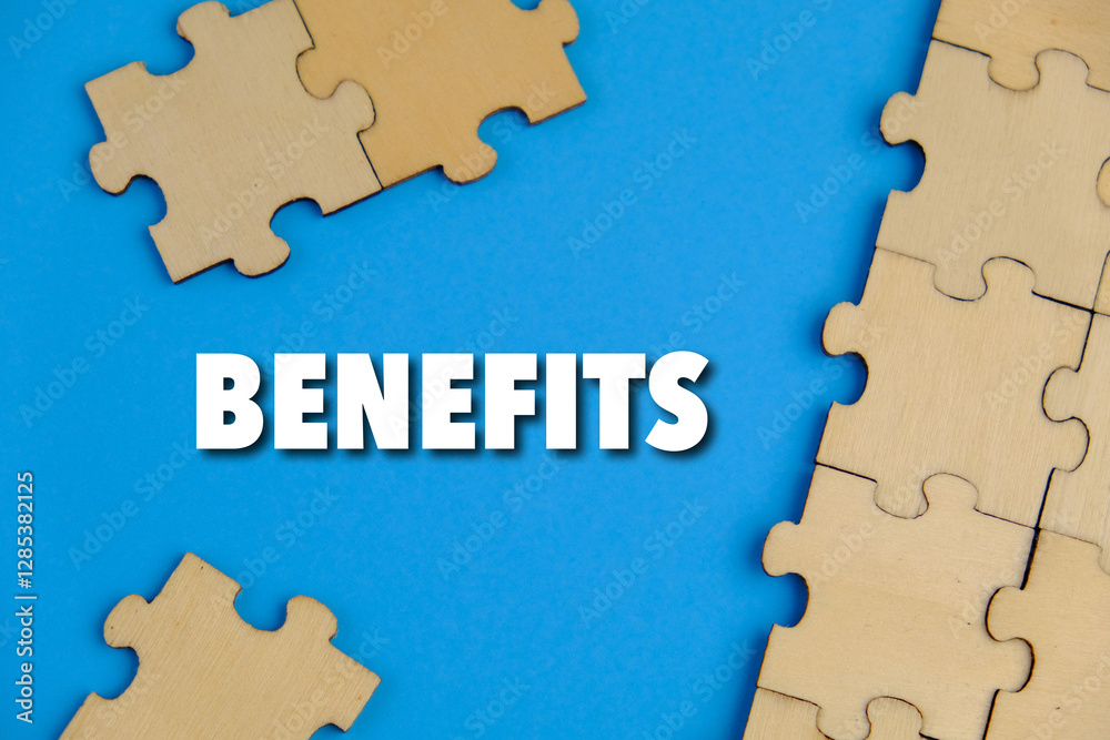 The word benefits on wooden puzzle o blue background. the concept of profit. business concept The word benefits on wooden puzzle o blue background. the concept of profit. business concept