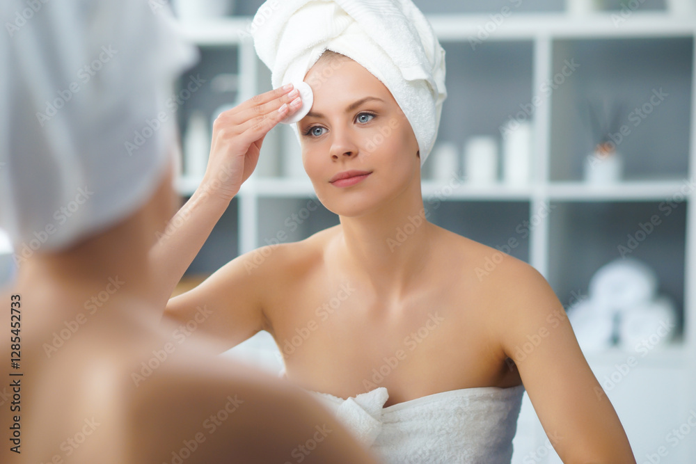 © Acronym - Young Girl is Sitting in front of a Make-up Mirror in the Bathroom and Applying a Skin Cream. Beautiful Woman is Making Cosmetic Rejuvenation Procedures. © Acronym - Young Girl is Sitting in front of a Make-up Mirror in the Bathroom and Applying a Skin Cream. Beautiful Woman is Making Cosmetic Rejuvenation Procedures.