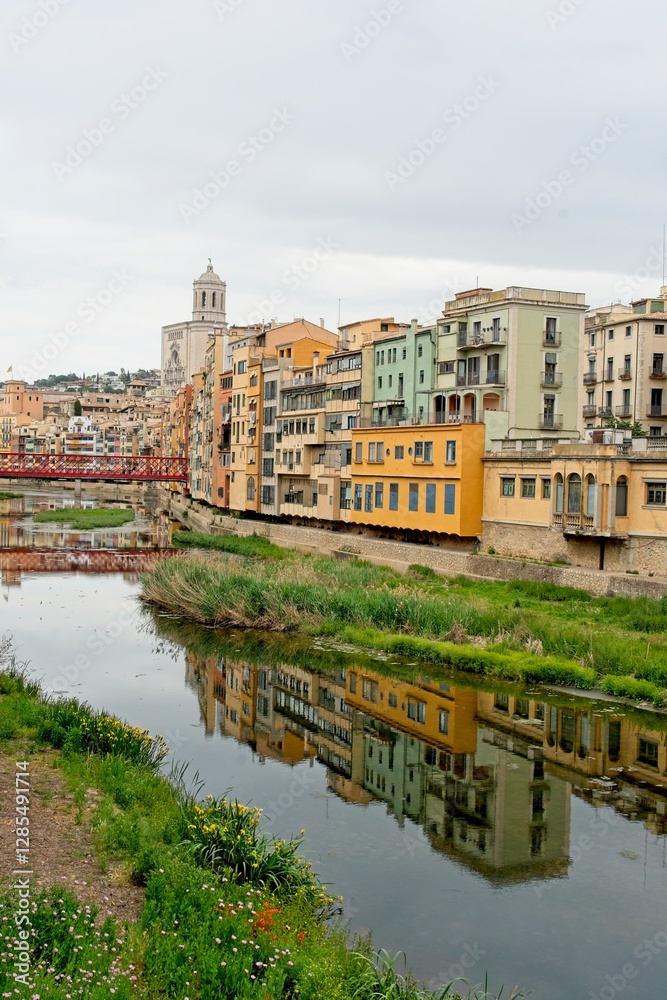 Naklejka premium Girona Spain - 25 April 2024 - Colourful houses along the Onyar River in Girona