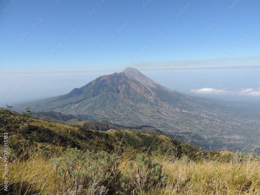 Fototapeta premium beautiful view of Merbabu mountain with clear and slightly cloudy sky