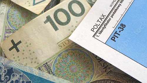 Polish tax form PIT-38 and PLN banknotes. Closeup. Top view