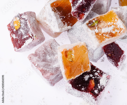 Sweet food Turkish delight, assorted rahat locum in form of cubes with nuts and powdered sugar, traditional food, on white background photo