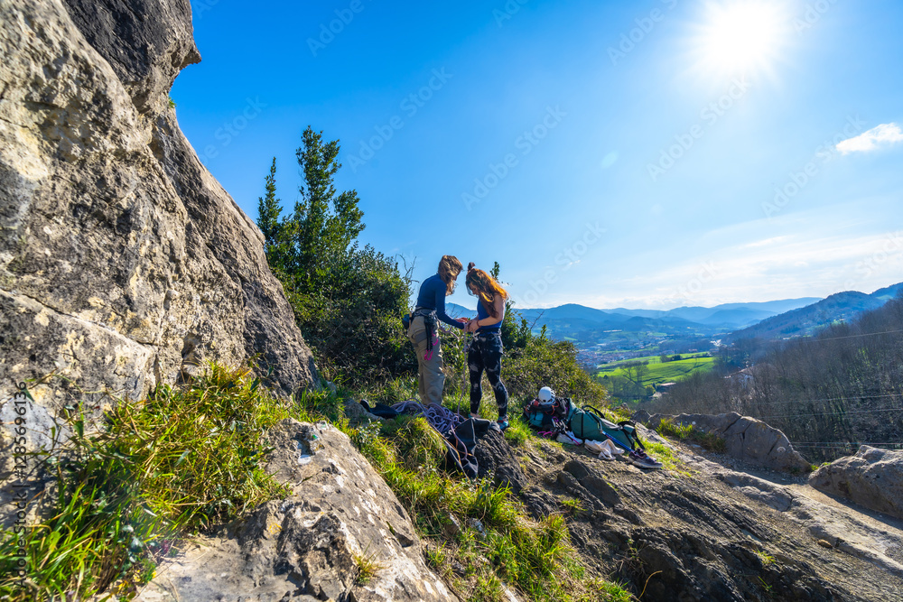 Adventurous women climbing a scenic mountain trail Adventurous women climbing a scenic mountain trail