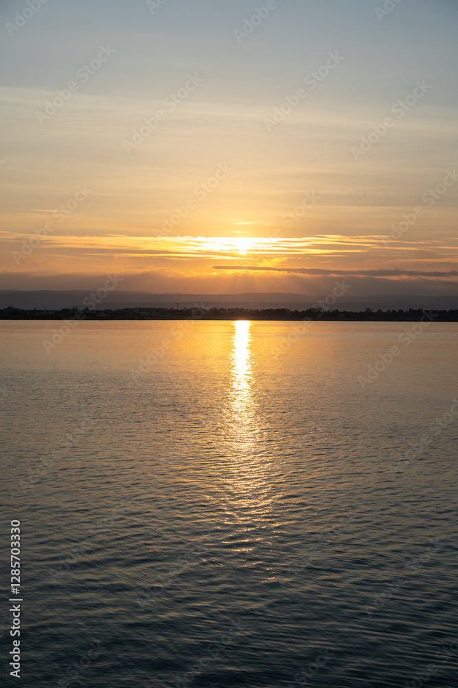 Sunset over the ocean, with the sun low on the horizon, contrast between sky and sea Sunset over the ocean, with the sun low on the horizon, contrast between sky and sea