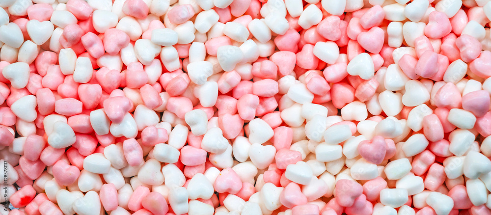 Panoramic background of sweet pink and white candy hearts