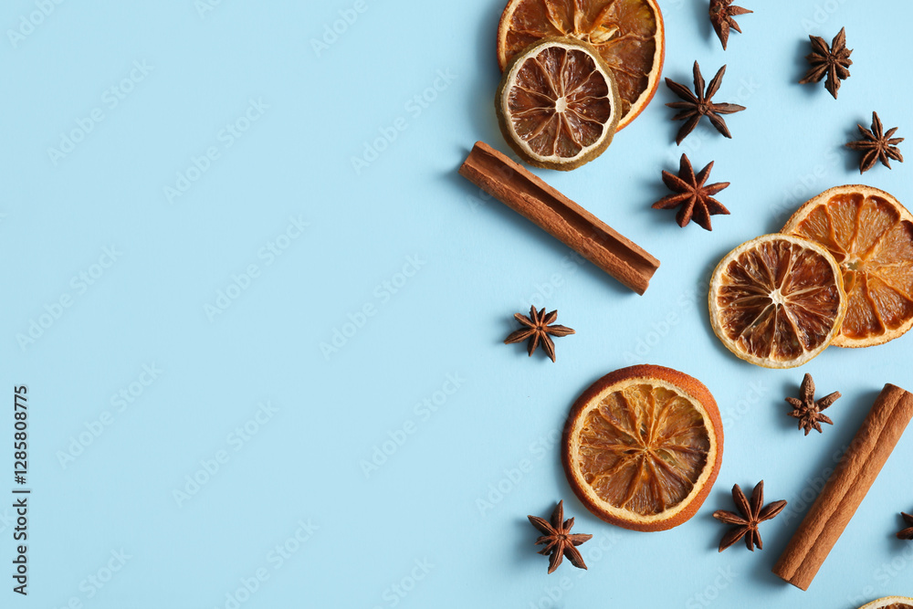 Dried orange slices with star anise and cinnamon on blue background