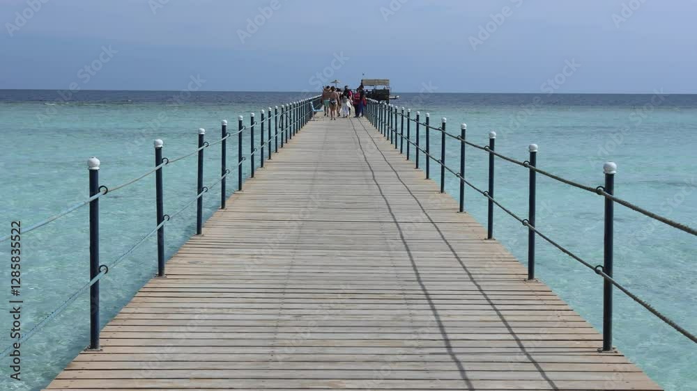 Tourists walking on a pier in marsa alam, egypt Tourists walking on a pier in marsa alam, egypt