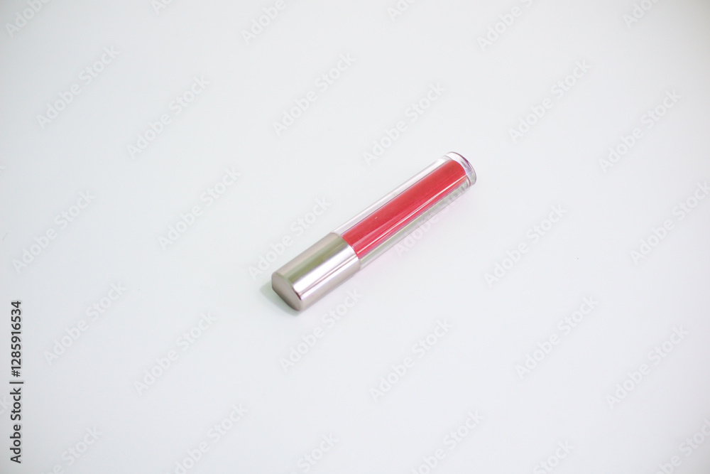 Red lip gloss in elegant glass bottle with shiny lid, container with brush isolated on white background, red lipstick Red lip gloss in elegant glass bottle with shiny lid, container with brush isolated on white background, red lipstick