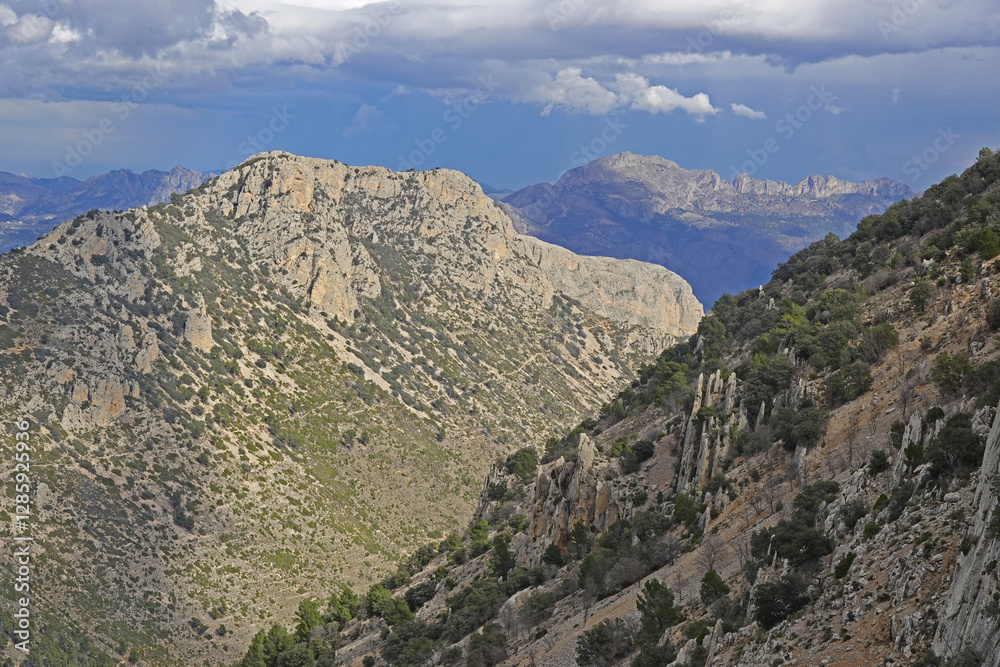 The mountain panorama opening from the hiking path to pick Puig Campana, Finestrat, Benidorm, Spain The mountain panorama opening from the hiking path to pick Puig Campana, Finestrat, Benidorm, Spain