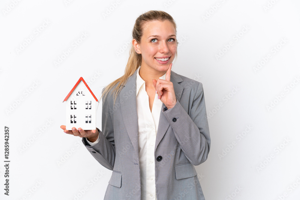 Real estate agent woman holding a toy house isolated on white background thinking an idea while looking up Real estate agent woman holding a toy house isolated on white background thinking an idea while looking up