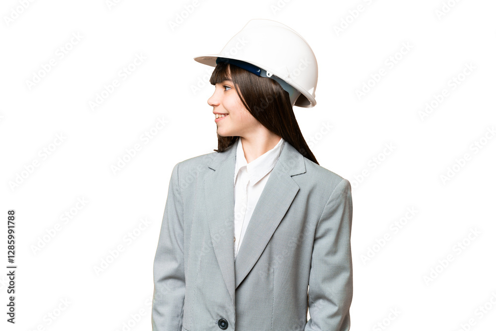 Little girl playing as a architect with helmet and holding blueprints over isolated background looking side Little girl playing as a architect with helmet and holding blueprints over isolated background looking side