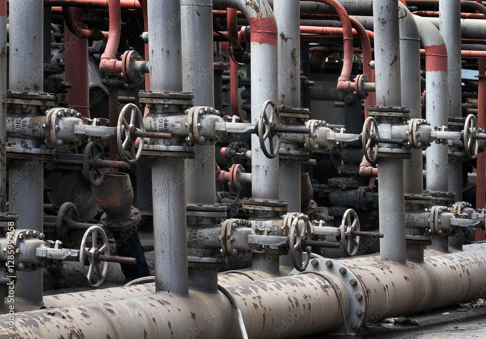 Series of pipes, valves and pumps transfering hot dangerous materials on a coke making works. Series of pipes, valves and pumps transfering hot dangerous materials on a coke making works.