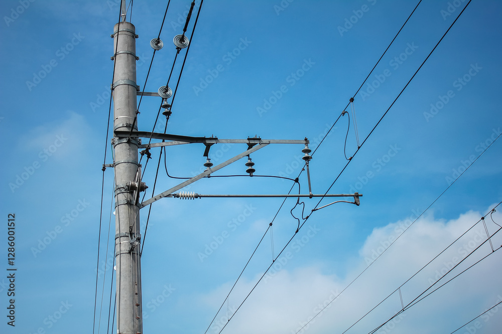 concrete electric pole with cables stretching across the blue sky concrete electric pole with cables stretching across the blue sky