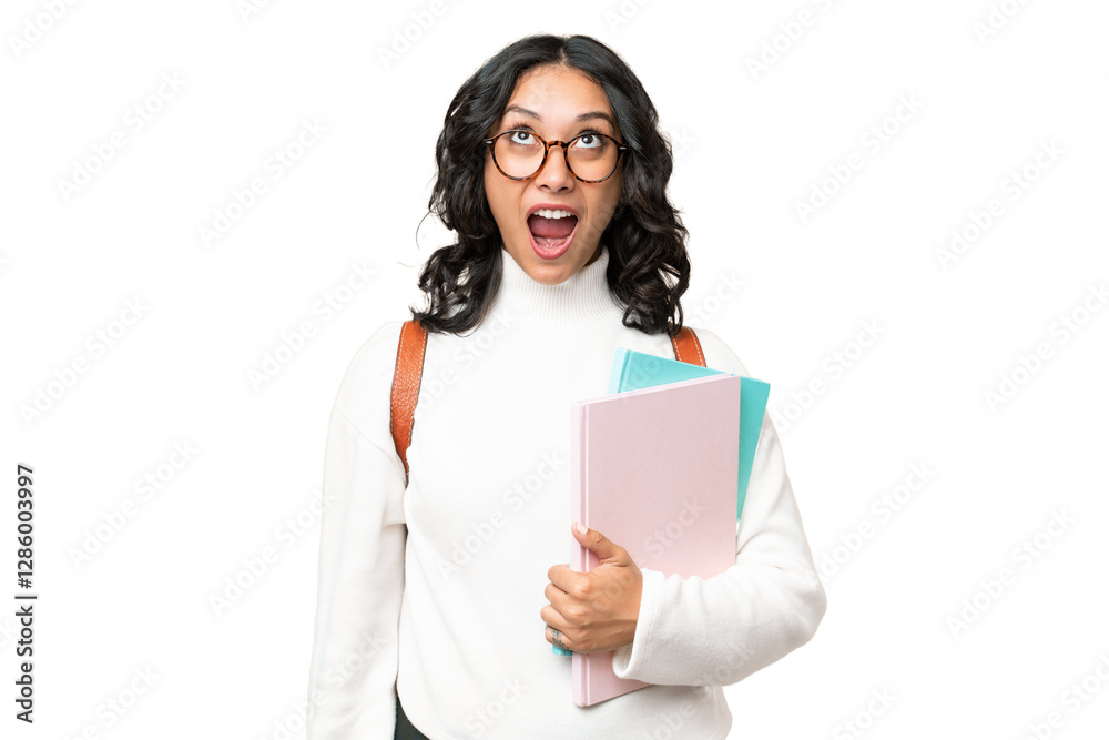 Young Argentinian student woman over isolated background looking up and with surprised expression Young Argentinian student woman over isolated background looking up and with surprised expression