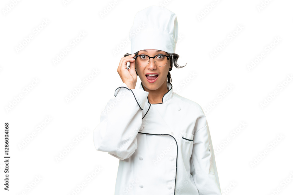 Young chef Argentinian woman over isolated background with glasses and surprised Young chef Argentinian woman over isolated background with glasses and surprised