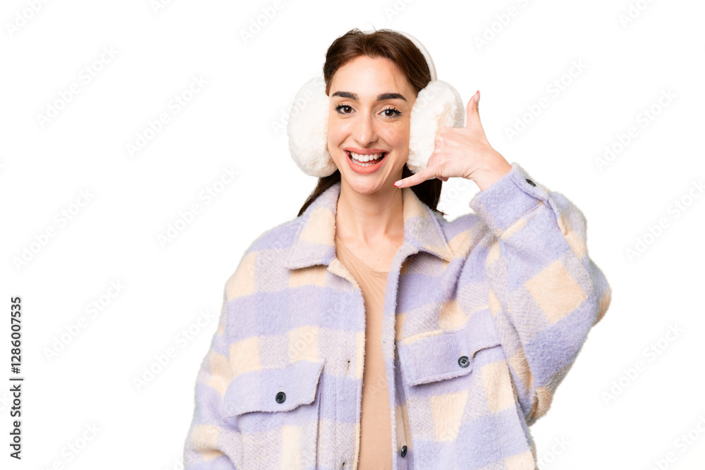Young caucasian woman wearing winter muffs over isolated chroma key background making phone gesture. Call me back sign Young caucasian woman wearing winter muffs over isolated chroma key background making phone gesture. Call me back sign