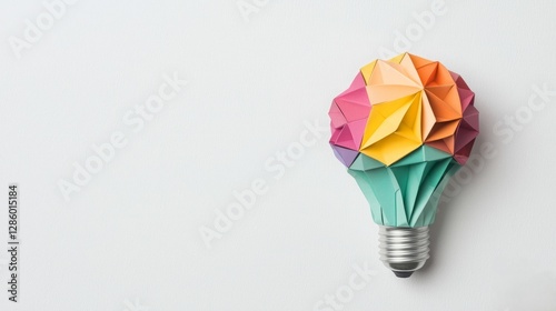 A colorful origami light bulb design, symbolizing creativity and innovation, set against a minimalist background.