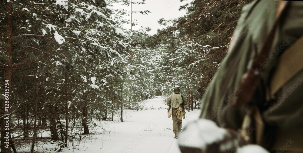 Usa Army Soldiers Of World War Ii. Heroes Of War. Re-enactors Dressed As American Infantry Soldier Marching Through Forest Road In Cold Winter Day. Group Of Usa Soldiers Marching Country Road