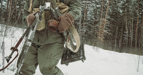 Obraz na płótnie Usa Army Soldiers Of World War Ii. Re-enactors Dressed As American Infantry Soldier Going Through Forest Road With Mortar. Two Usa Soldiers Marching By Country Road. w salonie