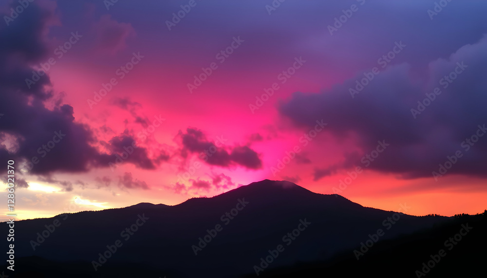 Obraz premium Vibrant Pink Sunset over Majestic Mountain Range Scenic View