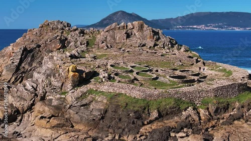 Ancient Hill Fort Of Castro de Baroña With The Atlantic Ocean At Background In Galicia, Spain. Aerial, Approaching Shot
