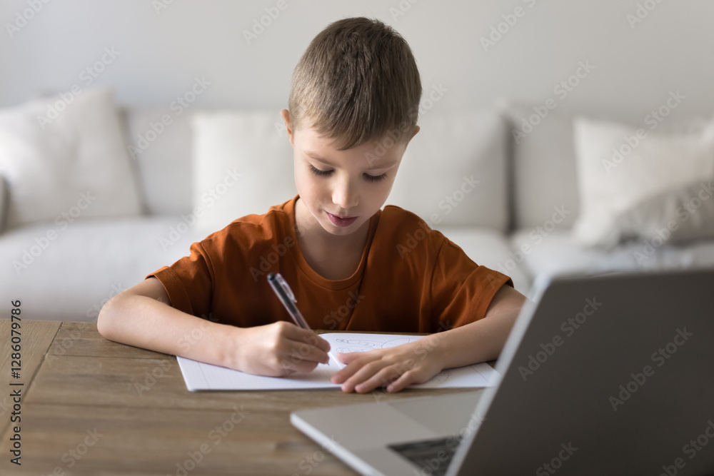 Cute little boy studying at home, writes in copybook sit at desk with laptop, e-learning, preparing school assignment, gain new knowledge using educational platform or app, look focused and interested Cute little boy studying at home, writes in copybook sit at desk with laptop, e-learning, preparing school assignment, gain new knowledge using educational platform or app, look focused and interested