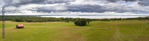 Panoramic view of green field and blue sky with clouds. Panoramic view of beautiful forest lake in Belarus