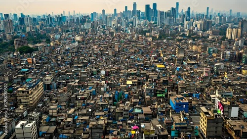 Aerial View of Mumbai's Dharavi Slum juxtaposed with the Modern Skyline: A Contrast of Urban Extremes