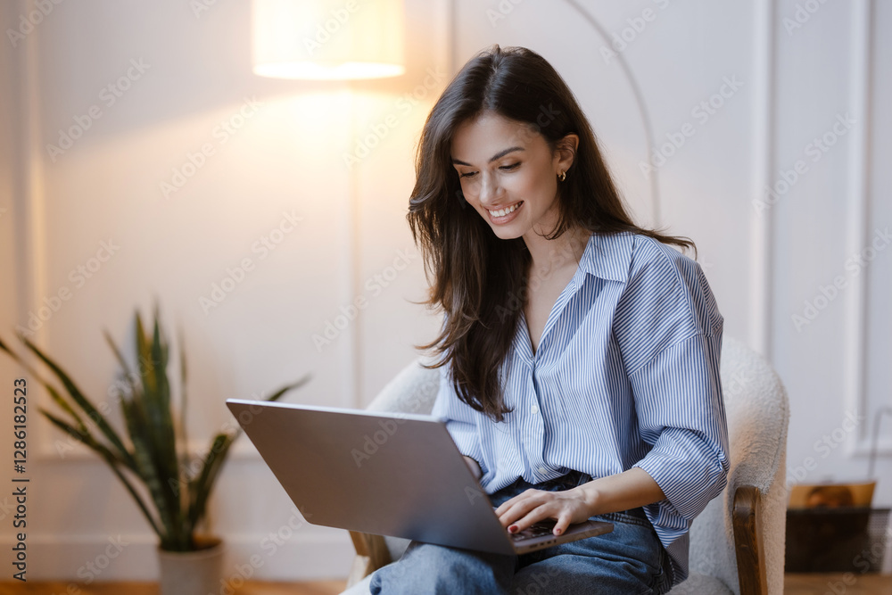 Fototapeta premium Woman doing her job on the laptop and smiling. Remote working girl.