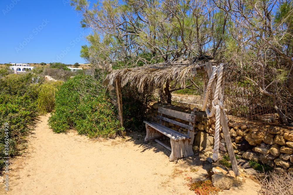 A bench on the coastal path of Ano Koufonisi island. Small Cyclades, Greece